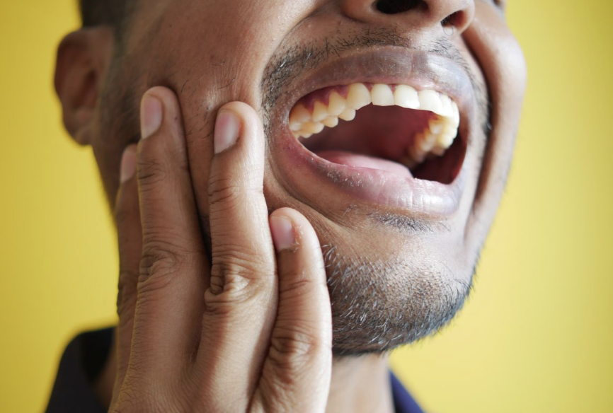 Patient experiencing tooth pain before seeing an emergency dentist in Louisville KY